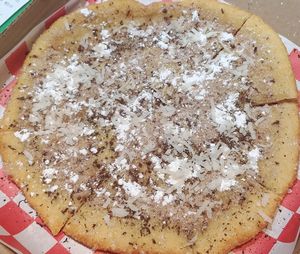 Vegan Sweety Pie Pizza : Sweet Fried Pizza Dough
Topped with cinnamon-fennel-cardamom powder and chocolate bites (vegan).  at Pizza & Sub Stop in Lowell