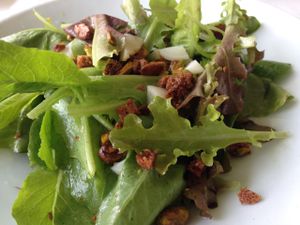 Sample vegan salad - garden greens with fennel vinaigrette, pistachios, and pickled daikon. at The Restaurant at Patowmack Farm in Lovettsville