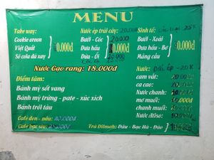 Menu posted on the wall by the entrance at Tu Hao in Hanoi