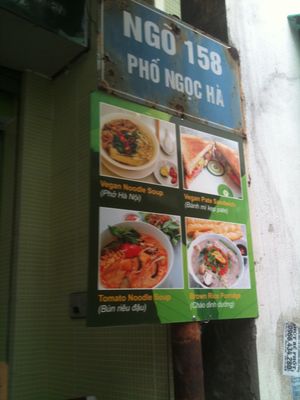 Front sign on the street, with display of some of there dishes at Cua Hang Thuc Pham An Chay Tot in Hanoi