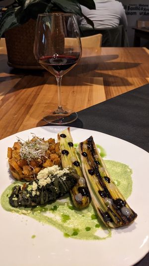 Porro arrosto con zucca alla scapece e cicoria ripassata, crema di aglio nero e gel di limone at 100% Bio in Rome