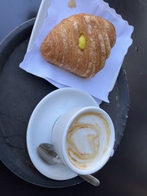 Lemon croissant and oat milk cappuccino   at 100% Bio in Rome