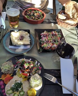 At the bottom: small vegan plate. Above: mashed potato and fried eggplant with tahini. Top: plate with mushrooms and hummus + bread at Aubergine in Bucharest
