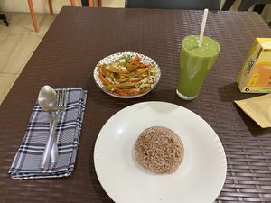 Fried veggies with rice and green smoothie   at Wellnessland Vegetarian Cafe in Cebu