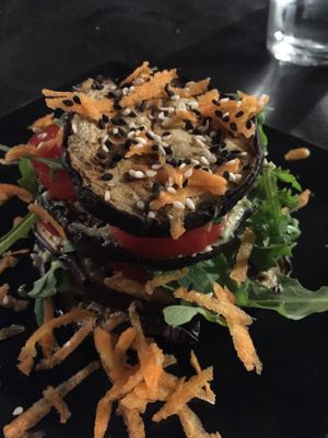 Grilled eggplant millefoglie with rocket, cherry tomatoes, grated carrots and a chickpea, tahini, herbs cream at Lizard in Rome
