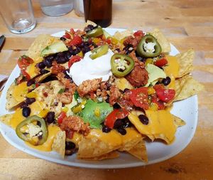 Loaded nachos (with nacho cheese, smoky tempeh, black beans, avocado, pico de gallo, tofu sour cream, and pickled jalapenos) at Cadence in Guelph