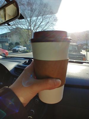 Hot coffee with oat milk and sugar, terrible, sour, didn't drink. We literally threw it away and got something else to drink at Vortex Doughnuts in Asheville