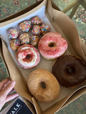 Glazed & sprinkled donut holes (my fav!), strawberry, strawberry cheesecake, chocolate, and cinnamon sugar 😋 got these for non-vegan family in town and they loved them!    at The Big O Doughnuts in Salt Lake City