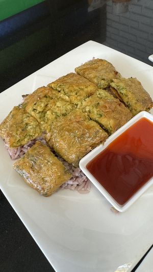 Mock “egg” omelette over ricee  at Guan Yim in Lampang