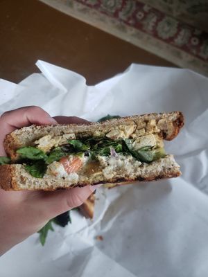 caprese tofu, tomato, onion, mixed greens, on rye bread at Two Beards Deli in Grand Rapids