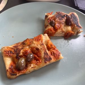 Focaccia con olive taggiasche e pomodorini   at Feliz Cafe in Peschiera Del Garda