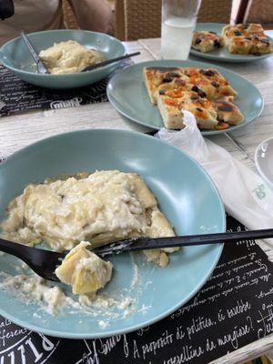 Mushroom lasagna and olive and tomato focaccia   at Feliz Cafe in Peschiera Del Garda