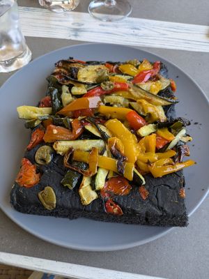 Focaccia with olives, tomatoes and Mediterranean veg at Feliz Cafe in Peschiera Del Garda
