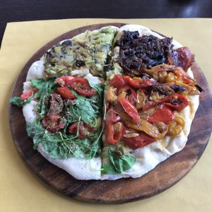 Delicious vegan pizza with vegan cheese and assorted vegetables  at Feliz Cafe in Peschiera Del Garda