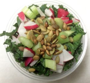 Shredded kale salad with celery, red radish and roasted pumpkin seeds. Served with a creamy seed  & scallion dressing. at 7th Element in Burbank