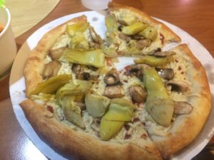 Person pizza with mushrooms and artichokes at Red Brick Pizza in Las Cruces