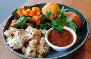 Vegan Arancini with potato salad and pumpkin and spinach salad. at The Laughing Owl in Belgrave
