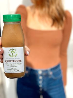 Coffee Cure organic cold brew coffee, sprouted almond milk, cinnamon, vanilla, sweetened with dates. at Thrive Juice Lab in Laguna Niguel