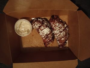 Bananas Foster empanadas with powdered sugar and icing on the side--ordered to go! at Bar Bombon in Philadelphia