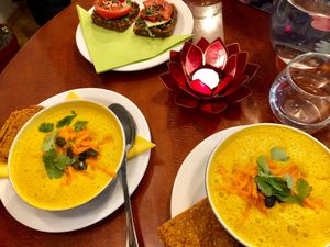 Raw warm carrot soup and raw bread with mustard and vegetables at bistRAW & Tea in Prague