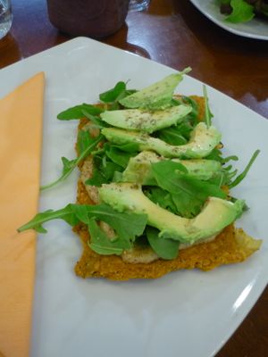 Pizza with avocado and arugula at bistRAW & Tea in Prague