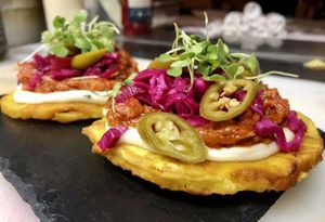 Patacones: Crispy Green Plantain, Garlic Aioli, Guava BBQ Jackfruit, Fermented Slaw & Cilantro

#Patacones
#FullBloomAppetizer
#DinnerMenu
#VeganMenu
#GourmetVeganCuisine at Full Bloom in Miami Beach