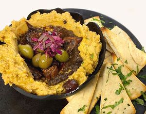 Truffle Hummus - Raw chickpea & hemp seed hummus, truffle paste, mediterranean olives, dry figs, arugula & pita. #LunchMenu #VeganFood #KosherFood #GlutenFree #SoyFree #NutFree at Full Bloom in Miami Beach