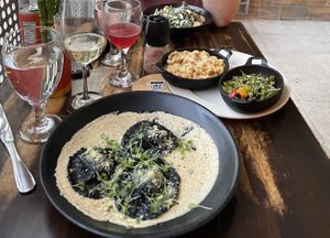 Black ravioli, Mac and cheese, tempeh, Caesar salad  at Full Bloom in Miami Beach