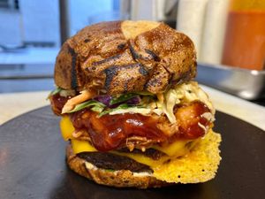 Bacon Cheese Burger - Beyond patty, smoked tempeh bacon, American cheese, onions, pickles, house burger sauce on pretzel bun. Served with roasted chimichurri potatoes. at Full Bloom in Miami Beach