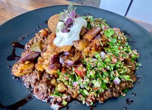 Maghmour by @chef_rojas - Spicy roasted eggplant, beluga lentils, chickpeas, summer squash stew, mushroom kofta, tabbouleh, yogurt & pomegranate syrup. Served with flat bread. at Full Bloom in Miami Beach