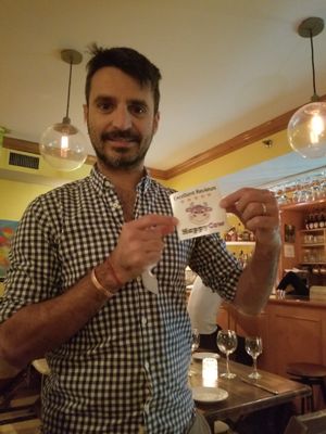 Giving a window sticker for their great reviews! at Full Bloom in Miami Beach