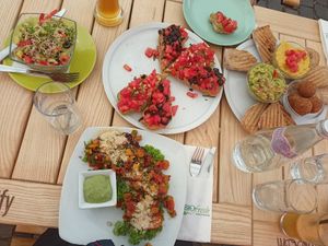 Avocado quinoa salad, filled sweet potatoes with tofu and veggies, hummus, guacamole, veggie balls, bruschetta, bread, juices, and beer. All delicious! at BIOFresh in Timisoara
