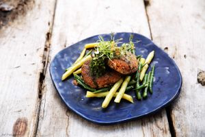 Quinoa, young beetroot and parmesan cheese cutlets served on green beans with sesame seeds and parsley pesto / vegetarian at Cafe Kulturalna in Warsaw