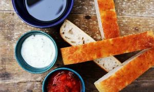  Slices of warm foccacia served with two dips and olive oil. at Cafe Kulturalna in Warsaw