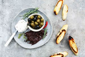 Creamy goat cheesee, red onion marmalade, olives, toasted bread at Cafe Kulturalna in Warsaw
