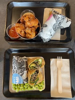Popcorn cauliflower, sushi burrito on top, bento box on bottom  at Happy Maki in Brighton