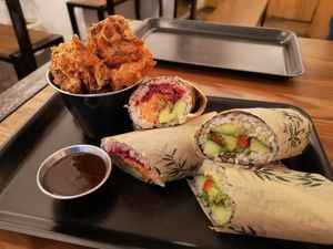 Popcorn cauliflower and teriyaki sauce, avocado kiss and rainbow maki with added mock duck at Happy Maki in Brighton