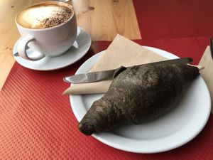 Soya cappuccino and vegan charcoal croissant at Purezza, Brighton.-from 2016 March, please check updated menu to see if this is still available or not at Purezza in Brighton