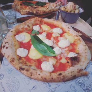 Cheesus and dough balls with calzone in the background at Purezza in Brighton