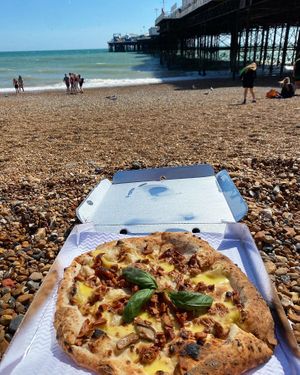 “The one that’s telling porkies” - White base with melted cheddar, mixed wild forest mushrooms, marinated pulled BBQ pieces and sundried tomatoes. at Purezza in Brighton