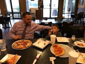 Somebody is happy with his pizza❣  at KC Artisan Pizza in Lakeland