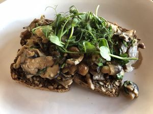 adaptogenic creamy mushrooms - shitake, chaga, lions mane, reishi, chestnut and nameko mushrooms in almond cream, mustard, parsley and garlic, served on seeded toast
 at Redemption - Chepstow in West London