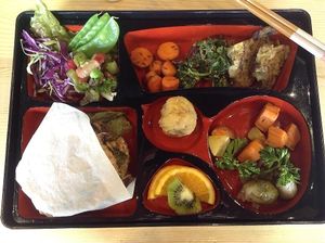 Bento Box.  Natto burger hiding under paper wrapping. at Tama Organic Life in Vancouver
