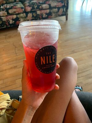 Straw kiwi tea with blueberry flavor so yum but syrup sits at the bottom so had to cover drinking hole to mix at The Nile in Mesa