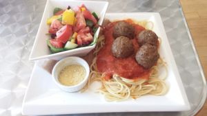 Spaghetti and meatballs with homemade cashew Parmesan cheese at Cosmic Treats in Toronto