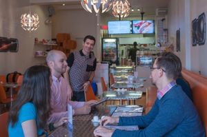 Owner Elliot Alexander with members of the Toronto Vegetarian Association at Cosmic Treats in Toronto