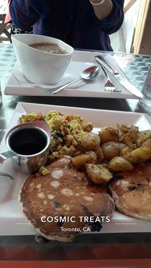 Choc chip & caramelized banana pancakes, tofu scramble, and home fries. at Cosmic Treats in Toronto