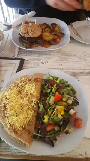 Burger with baked patatoes and buckwheat crêpe with spinach and cheese with salad   at CsendesM Vegan Bistro in Budapest