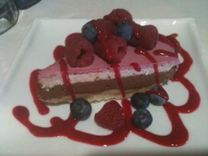 Chocolate Pie w/ Vanilla and berry sauce!  Yummy!!! at Rawtopia Living Cuisine and Beyond in Millcreek
