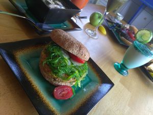 Krab kake sandwich served fresh organic salad. at Eden's Vegan Juice Bar Cafe in Palm Coast